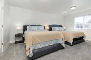 Carpeted bedroom featuring baseboards