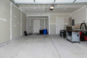 Garage featuring electric panel and a garage door opener