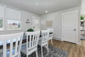 Dining space with light wood finished floors, plenty of natural light, and recessed lighting