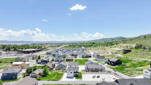 Aerial perspective of suburban area featuring a mountainous background