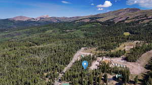 Aerial view of property and surrounding area featuring mountains