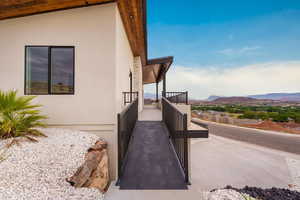 View of side of home with stucco siding and a mountain view