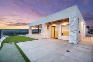 View of patio with a putting area