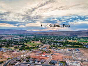 Aerial view of property's location featuring mountains and nearby suburban area