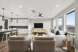 Living room featuring light wood finished floors, recessed lighting, and ceiling fan