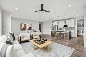 Living area featuring dark wood finished floors, recessed lighting, and a ceiling fan