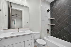 Bathroom with tub / shower combination, vanity, and a ceiling fan