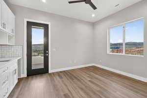 Kitchen with white cabinetry, backsplash, healthy amount of natural light, and recessed lighting