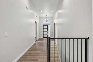 Foyer entrance featuring a chandelier, wood finished floors, and recessed lighting