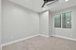 Empty room featuring carpet flooring, ceiling fan, and recessed lighting