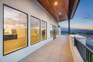 Balcony at dusk featuring a mountain view