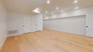 Bonus room with light wood finished floors and recessed lighting