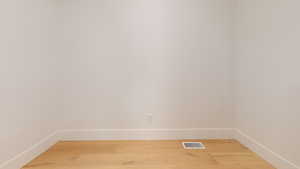 Spare room featuring baseboards and light wood finished floors