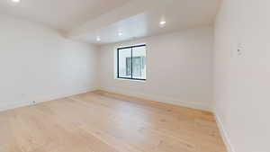 Empty room featuring light wood-style flooring and recessed lighting