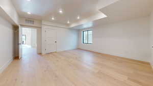 Unfurnished room with light wood-type flooring and recessed lighting