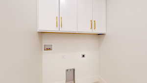 Laundry area featuring hookup for an electric dryer, cabinet space, and washer hookup