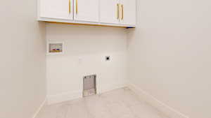 Laundry area featuring cabinet space, hookup for an electric dryer, light marble finish floors, and hookup for a washing machine