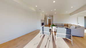 Dining space featuring recessed lighting, light wood-type flooring, and a premium fireplace