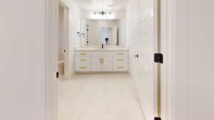 Bathroom featuring vanity and light marble finish flooring