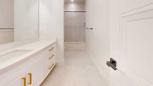 Full bathroom featuring vanity, shower / bathtub combination, and light marble finish flooring