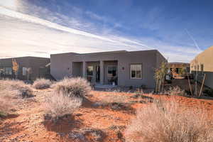 View of front of property with a patio area and stucco siding