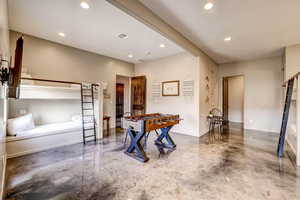 Playroom featuring recessed lighting and concrete flooring