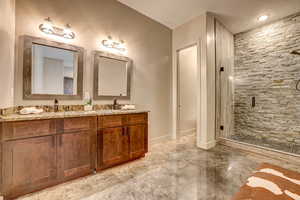 Full bathroom with a shower stall and double vanity