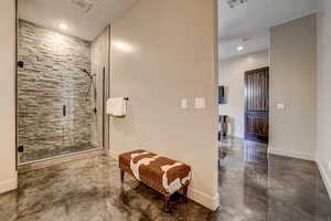 Bathroom with finished concrete flooring, a stall shower, recessed lighting, and a textured ceiling