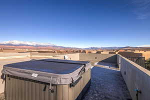 View of swimming pool featuring a hot tub, a mountain view, and a patio area