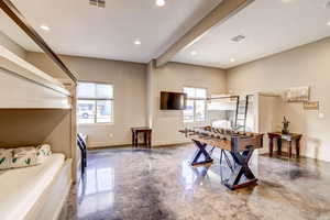 Playroom featuring beamed ceiling, concrete floors, and recessed lighting