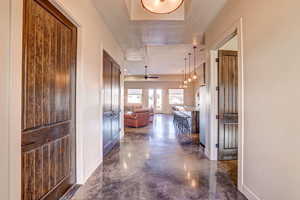 Corridor with baseboards and finished concrete flooring