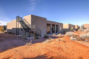Back of house with a patio, stairway, and stucco siding