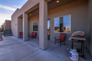 View of patio with a grill