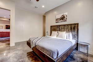 Bedroom with finished concrete floors, recessed lighting, and a ceiling fan