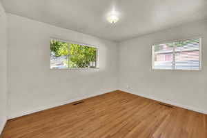 Spare room with wood finished floors