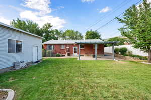 Back of house with a patio area and brick siding