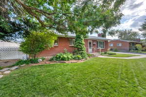 Ranch-style home with brick siding and a chimney