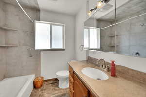 Bathroom featuring vanity and shower / washtub combination