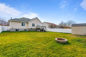 Rear view of property with an outdoor fire pit, a fenced backyard, stairs, a wooden deck, and an outdoor structure