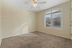 Empty room with carpet floors and a ceiling fan
