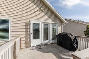 Wooden terrace featuring area for grilling