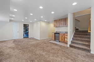Bar area with recessed lighting, light colored carpet, and stairway