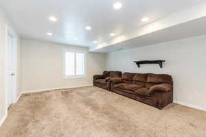 Living room with recessed lighting and light carpet