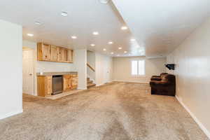 Unfurnished room featuring light carpet, stairs, and recessed lighting