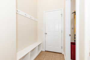 Mudroom with light tile patterned flooring