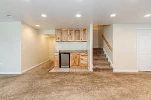 Kitchen featuring recessed lighting, light colored carpet, and light brown cabinets