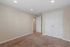 Unfurnished bedroom featuring carpet floors, a closet, and recessed lighting