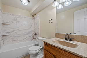 Full bath featuring bathing tub / shower combination, vanity, and a chandelier