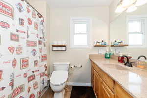 Bathroom featuring vanity, dark tile patterned flooring, and a shower with curtain