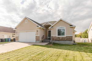 View of front of property featuring stone siding, an attached garage, stucco siding, and concrete driveway